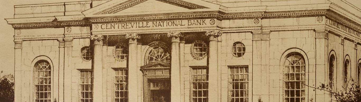 Classical white marble building with tall Corinthian columns, ornate pediment, arched windows, and symmetrical neoclassical architecture featuring a central entrance portico.