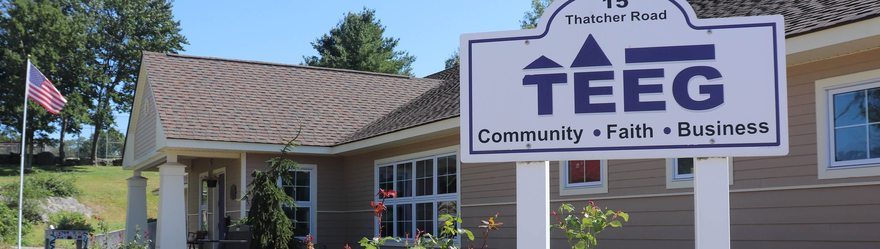 Sign reading TEEG, Community Faith Business, at 15 Thatcher Road outside a single-storey building